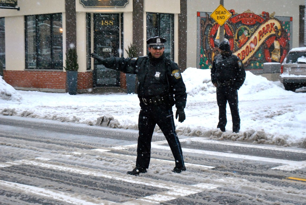Officer Javier Perez directs traffic outside the Curley on Feb. 13, 2014.