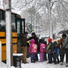 Students from the Curley board their bus on Feb. 13, 2014.