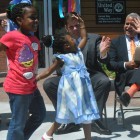 A Nurtury student high-fives Mayor Marty Walsh as Nurtury CEO Wayne Ysaguirre looks on at the ribbon cutting for the Nurtury Learning Lab on June 16, 2014.
