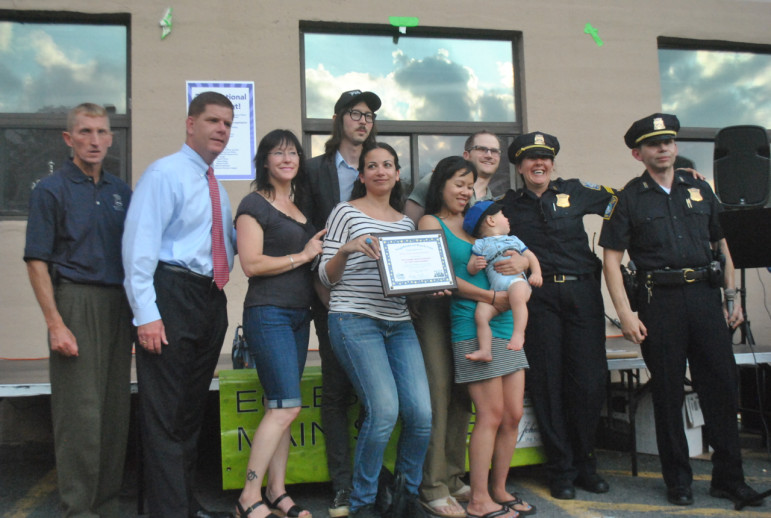 Members of the Brewery District Neighborhood Watch display their "Crime Watch of the Year" award, flanked by from left: Police Commissioner William Evans, Mayor Marty Walsh, Officer Beth Leary and Captain Alfredo Andres on Monday, Aug. 4, 2014.