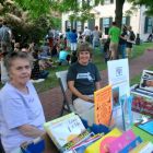 Peg Moloney, longtime board member of Friends of the JP Branch Library, works that group's table with Gretchen Grozer at First Thursday on Thursday, Sept. 4, 2014