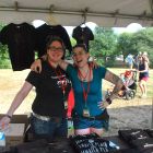 Hope Zimmerman, right, of Hope and the Husbands, and Hilary Alder work the merch tent at the Jamaica Plain Music Festival, Saturday, Sept. 6, 2014.