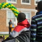 A student takes video of State Rep. Jeffrey Sánchez speaking at the ribbon cutting for the new playing field at Curley K-8.